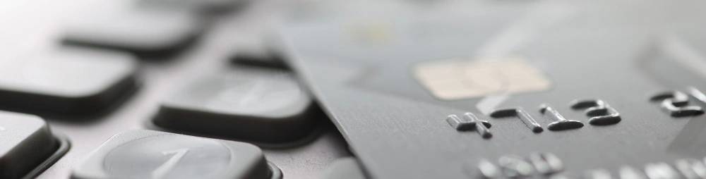 A payment card with an EMV chip rests beside a numeric keypad.