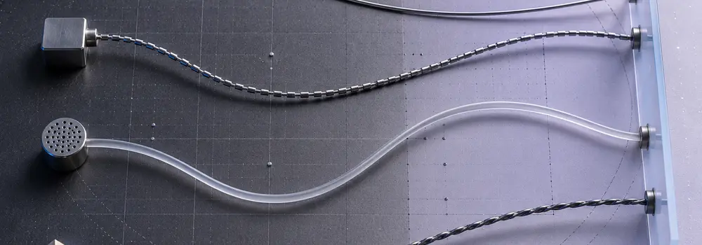 Four distinct precision curves crossing a technical surface, representing non-interchangeable elliptic-curve constructions.