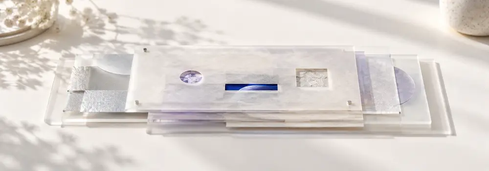 Layered translucent sheets with selected windows revealing only parts of an underlying record.