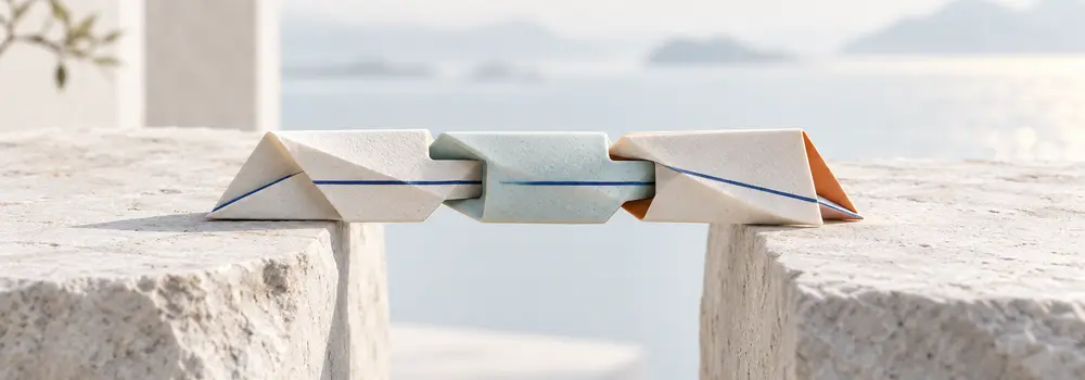 Three small interlocking folded elements form a bridge carrying one continuous blue line.